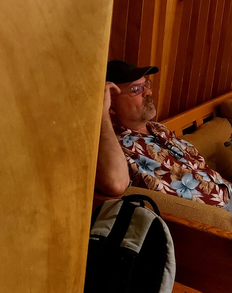 Peter Vantine sitting on couch in control room.